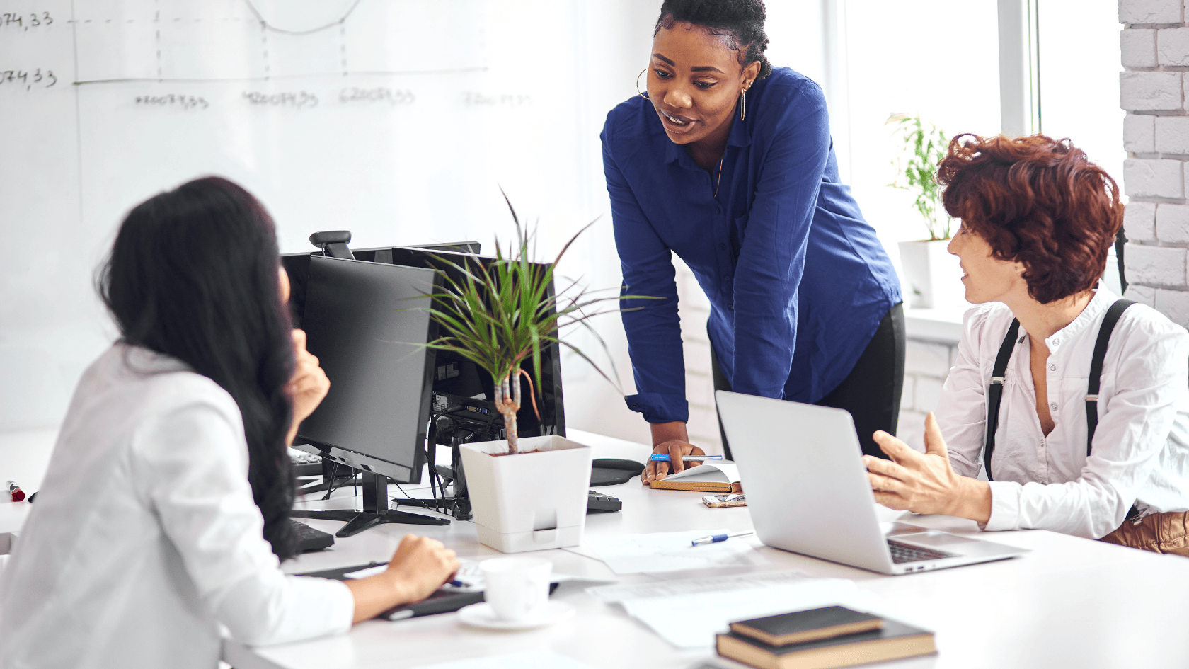 People speaking at desk
